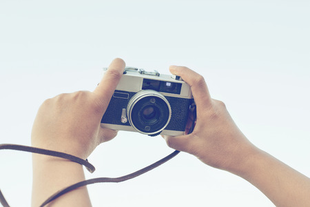 Woman hand holding camera for selfie vintage effect Stock Photo