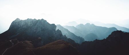 View on the mountains covered in fog from mangart pass that connects italian and slovenian side mangart pass Фото со стока