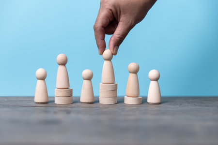 Building a strong team wooden blocks with people icon on blue background human resources and management concept