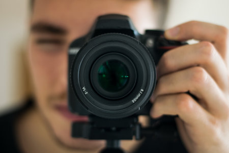 Close up of a boy taking a picture with a professional camera concept of photography hobby business