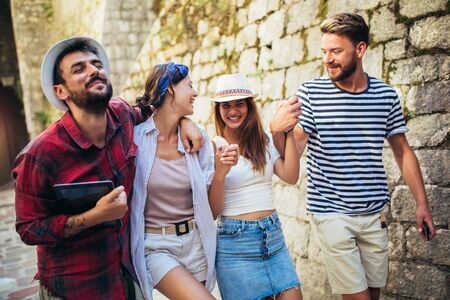 Happy group of tourists traveling and sightseeing together