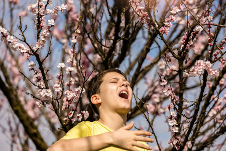 Child with pollen allergy boy sneezing because of seasonal allergy