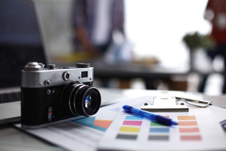 Laptop and camera on the desk with folder Stock Photo