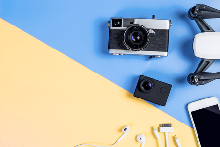 Hi tech travel gadget and accessories on blue and yellow copy space top view flat lay Stock Photo