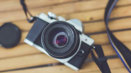 Top view of camera on bamboo table background vintage color tone