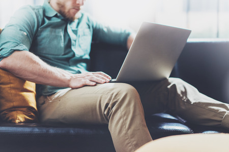 Bearded banker working laptop modern interior design loft studio man sitting vintage chair use contemporary notebook blurred background creative process new startup idea horizontal film effect