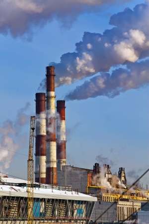 Thermal power station pipes smoke over a city