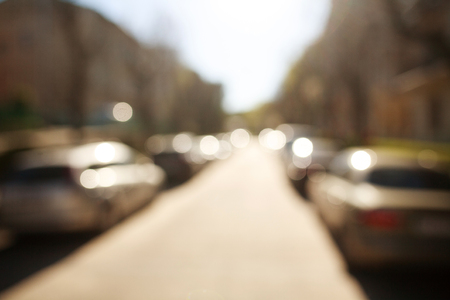 Blurred background city street with cars parked