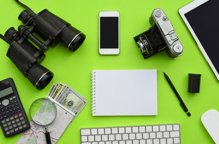 Flat lay of accessories on green desk background of photographer voyage concept