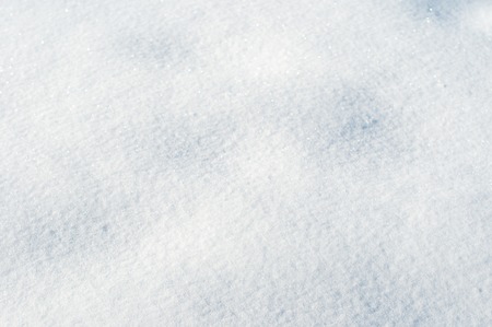 Texture of light fresh snow natural background of winter with blue snow