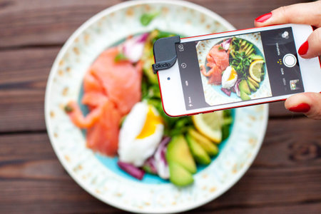 Brunch with poached egg avocado arugula flax seeds and salted salmon on a rustic wooden background flat lay horizontal copy space Stock Photo