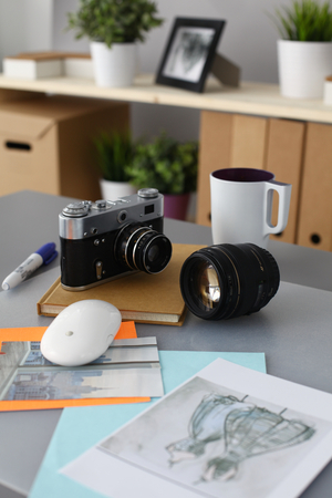 Designers table with camera and tools cup