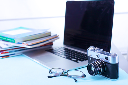 Digital camera and colour swatches on an office desk Stock Photo