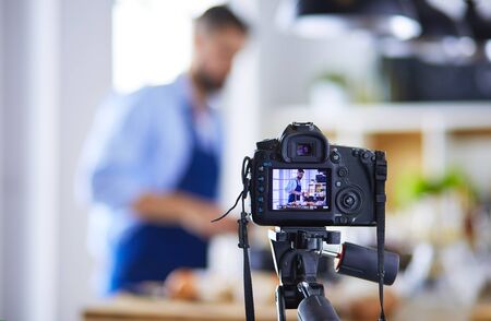 Man holding paper bag full of groceries on the kitchen background shopping and healthy food concept