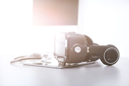 Virtual reality goggles on desk with laptop business 3d technology