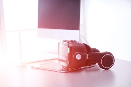 Virtual reality goggles on desk with laptop business 3d technology Stock Photo