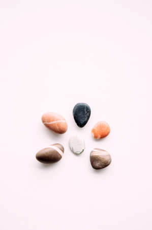 Flat lay of sea pebbles on light background abstract wallpaper