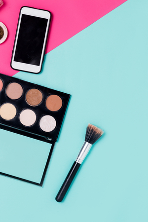 Close up of flat lay photo makeup products and smartphone on colorfull background with copy space for text top view minimalism concept Stock Photo