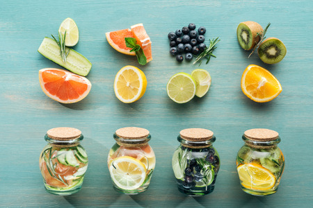 Top view of fruits and blueberries on blue textured surface Stock Photo