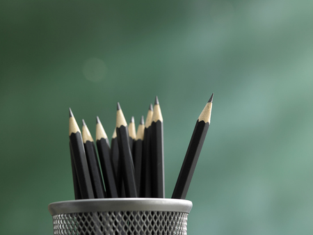 Pencil in front of blackboard concept stand out from the crowd