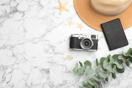 Flat lay composition with professional photographer camera passport and space for text on white marble table Stock Photo