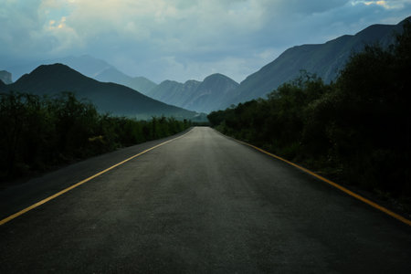 Beautiful view of empty asphalt highway near mountains outdoors road trip Stock Photo