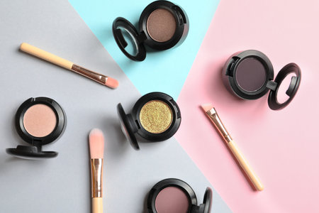 Flat lay composition with different eye shadows on color background Stock Photo