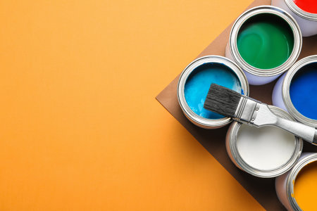 Flat lay composition with paint cans and space for text on color background