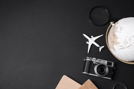 Travel blogger flat lay composition with vintage camera on black background space for text