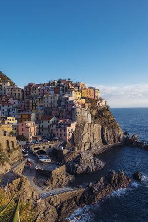 Splendida vista sulle colline rocciose e sui colorati edifici storici di Manarola, attrazione turistica e luogo famoso in Liguria, Italia. Collina sul mare al tramonto.