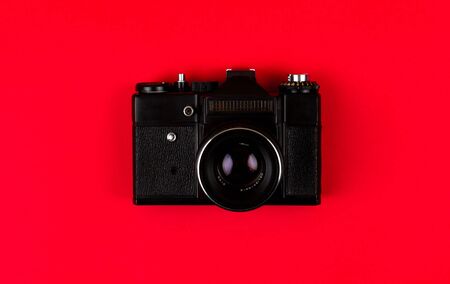 Flat lay film camera isolated on red background copy space Stock Photo