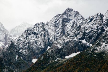 Snowy mountains with severe rocky peaks in dombay caucasus karachay cherkessia russia