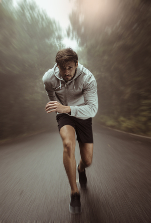 Handsome fit athlete running fast Stock Photo