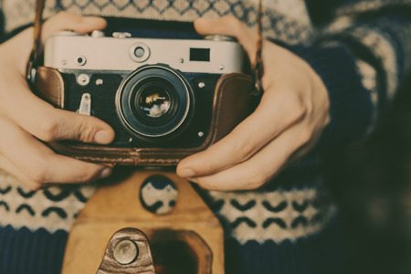 Man holding old retro camera in hands Stock Photo