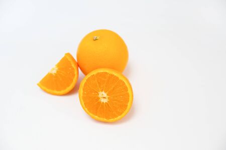 Composition of whole orange and cut orange laying together isolated on white background close up side view citrus fruit and healthy food concept