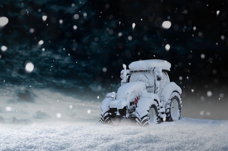 Snowbound tractor in the snow Stock Photo