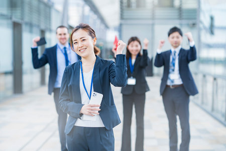 The business team in a suit smiles and poses for cheering Stock Photo