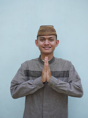 Moslem asian man smiling to give greeting during ied celebration