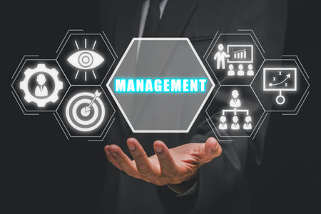 Management concept businessman hand holding management icon on virtual screen Stock Photo