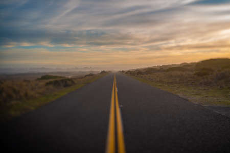 Selectively blurred road and horizon with sunset sky