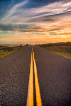 Highway with yellow lines and sunset sky selective focus dreamy pic