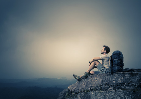 Hiker relaxing on top of the mountain Stock Photo