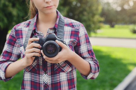 Unrecognizable woman photographing outdoors on professional camera copy space taking photos and photography classes concept