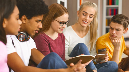 Intelligent girl reading essay to other students Stock Photo