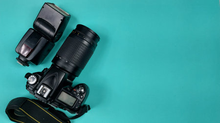 Camera with lens on a turquoise background with copy space Stock Photo