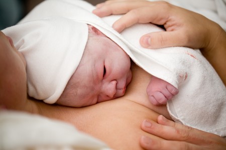 Newborn baby girl right after delivery shallow focus