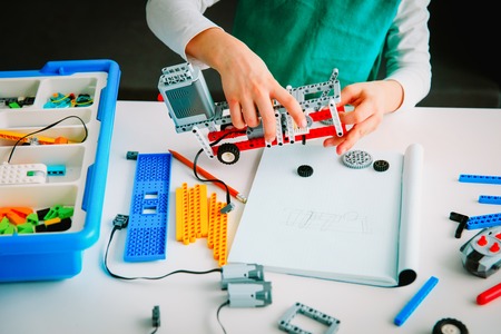 Little boy building robot at robotic technology lesson Stock Photo