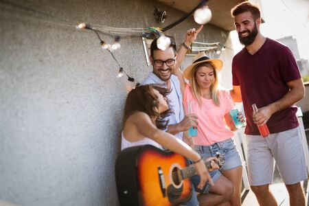 Feliz grupo de jóvenes amigos divirtiéndose en verano