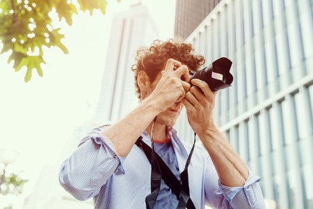 Professional photographer taking picture in city