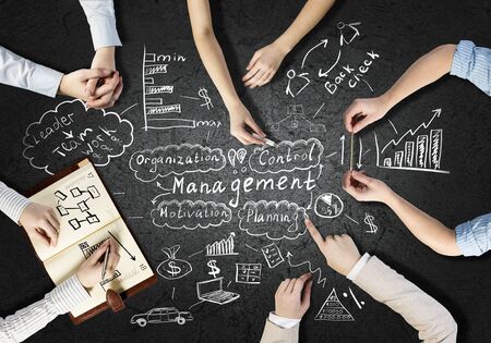 Top view of people hands drawing business teamwork strategy